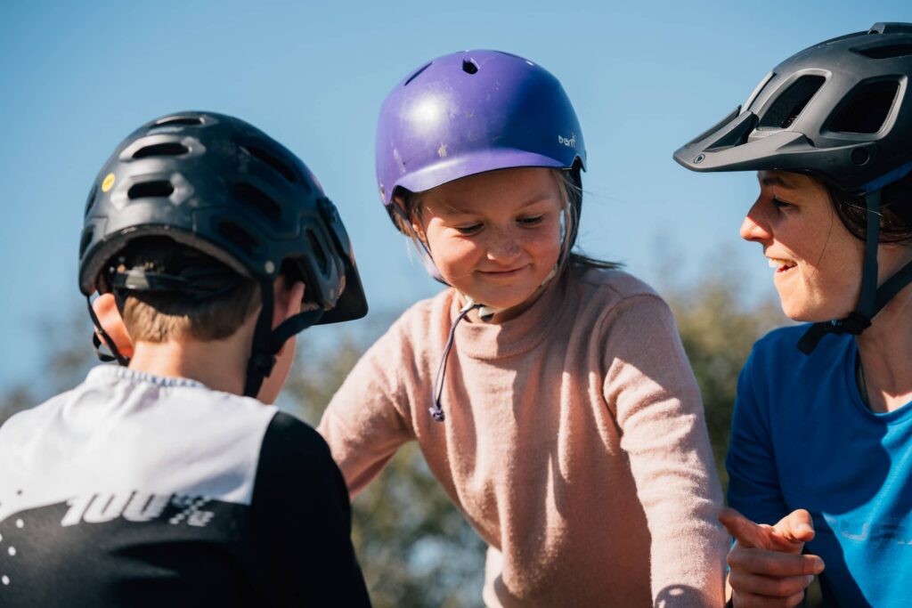 child riding a bike with adults