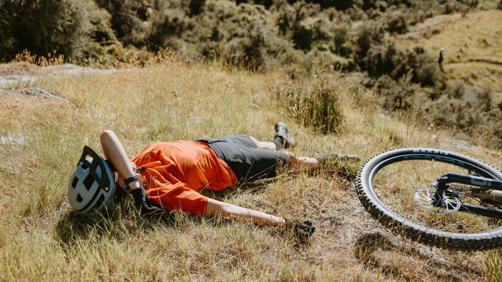 Bike rider lying in the grass at Bike Glendhu.